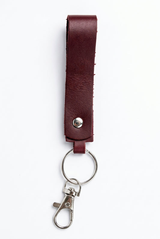 Handmade red-brown leather keychain loop by Killer Vibez featuring a durable key ring and lobster clasp, measuring approximately 5.5 inches long.